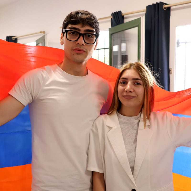 Two Youth Horizons Armenia participants holding the Armenian flag
